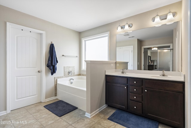 507 Romper Rd, Sneads Ferry, NC 28460 - full bathroom with double vanity, baseboards, a sink, and a garden tub