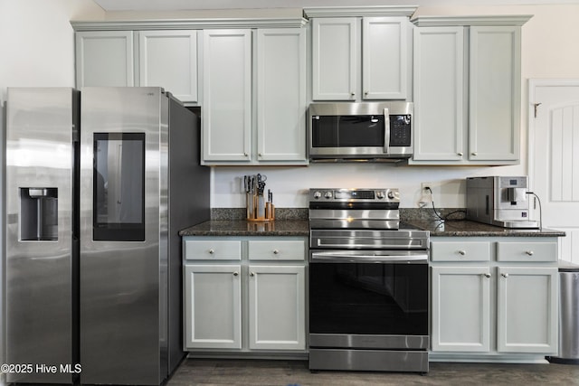 507 Romper Rd, Sneads Ferry, NC 28460 - kitchen with gray cabinetry, appliances with stainless steel finishes, dark wood finished floors, and dark stone countertops