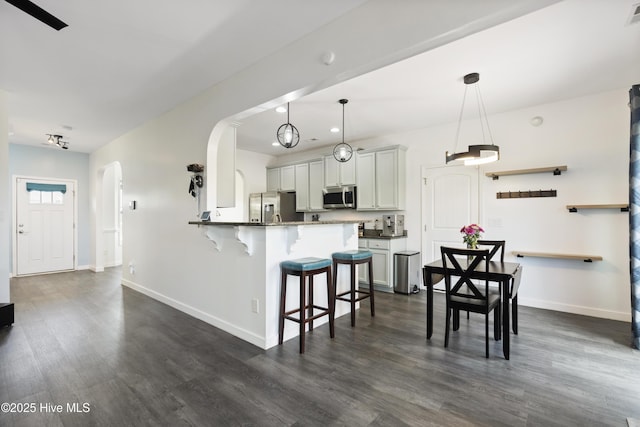 507 Romper Rd, Sneads Ferry, NC 28460 - kitchen featuring appliances with stainless steel finishes, baseboards, a kitchen bar, and arched walkways