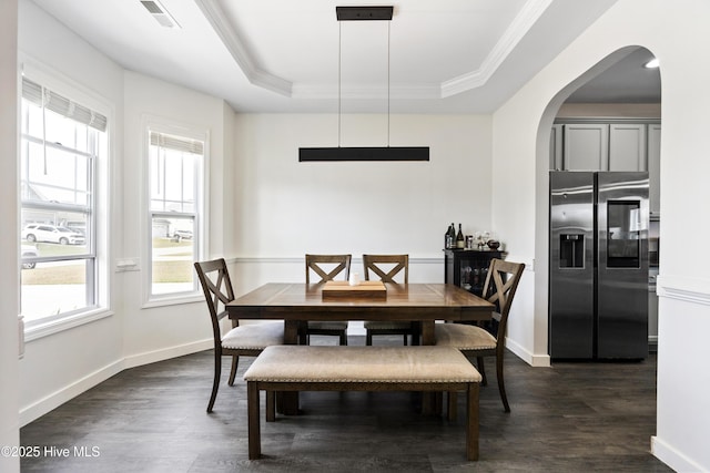 507 Romper Rd, Sneads Ferry, NC 28460 - dining space with a raised ceiling, arched walkways, dark wood-style floors, and visible vents