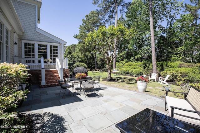 view of patio / terrace with outdoor dining area and a grill