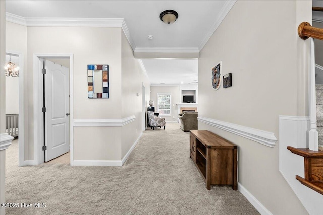 corridor featuring crown molding, carpet floors, baseboards, and stairway