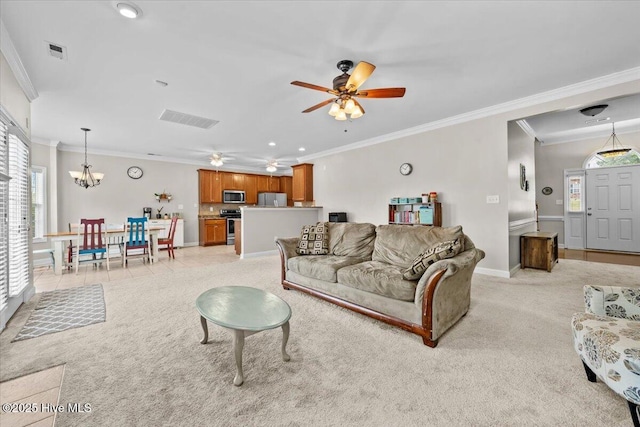 living room featuring crown molding, ceiling fan with notable chandelier, and visible vents