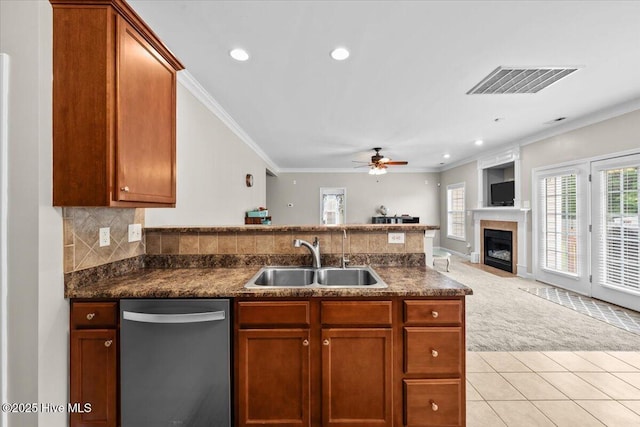 kitchen featuring a sink, dark countertops, stainless steel dishwasher, and visible vents