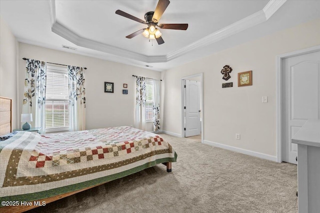 bedroom with carpet floors, baseboards, a tray ceiling, visible vents, and ornamental molding