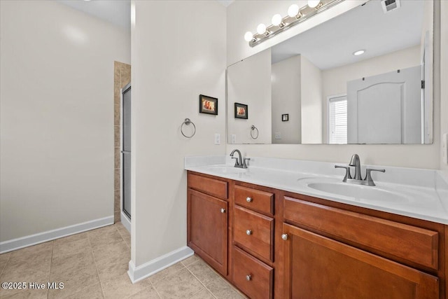 full bathroom with a sink, baseboards, and a stall shower