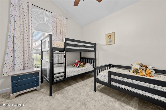 bedroom featuring carpet floors, a ceiling fan, baseboards, and vaulted ceiling
