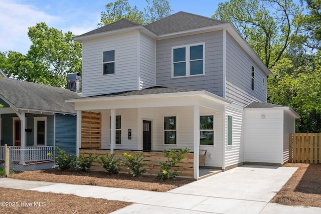 view of front of property with covered porch, fence, driveway, and a shingled roof