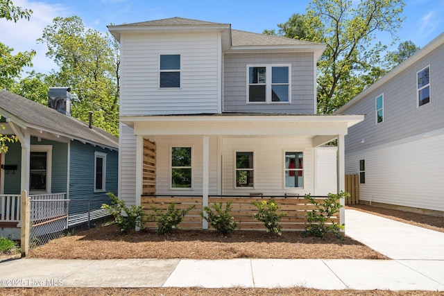 view of front of property featuring a shingled roof and a porch