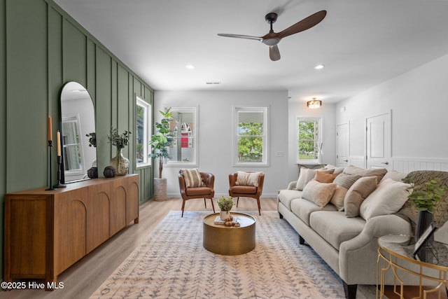 living room featuring recessed lighting, a ceiling fan, light wood finished floors, and visible vents