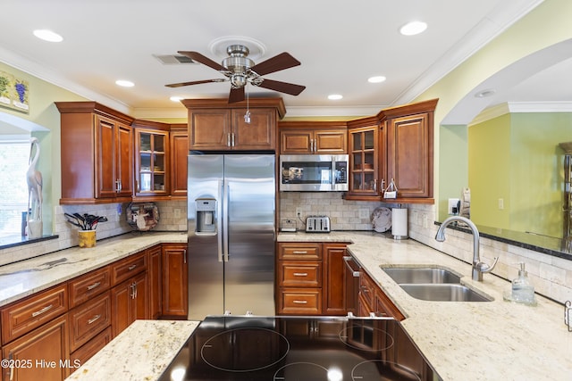 121 NW 1st St, Oak Island, NC 28465 - kitchen with ceiling fan, appliances with stainless steel finishes, arched walkways, tasteful backsplash, and a sink