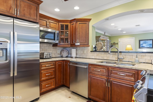 121 NW 1st St, Oak Island, NC 28465 - kitchen featuring crown molding, light stone countertops, a sink, backsplash, and stainless steel appliances