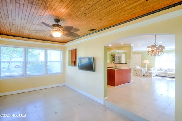 121 NW 1st St, Oak Island, NC 28465 - interior space with arched walkways, baseboards, visible vents, and plenty of natural light