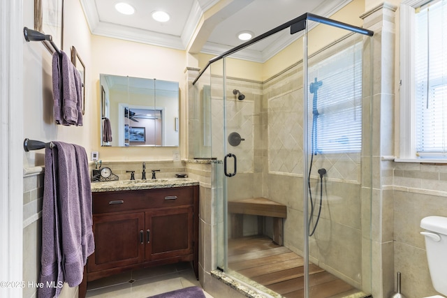 121 NW 1st St, Oak Island, NC 28465 - full bathroom featuring vanity, toilet, tile walls, a shower stall, and ornamental molding
