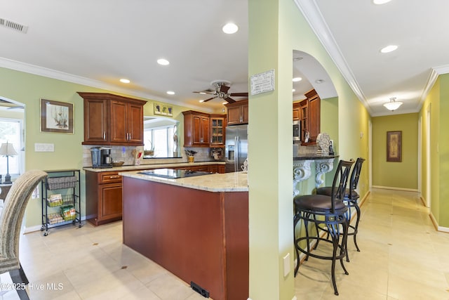 121 NW 1st St, Oak Island, NC 28465 - kitchen featuring stainless steel fridge, a ceiling fan, crown molding, and backsplash