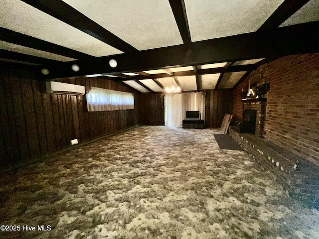 interior space featuring lofted ceiling with beams, a fireplace, carpet flooring, and wood walls