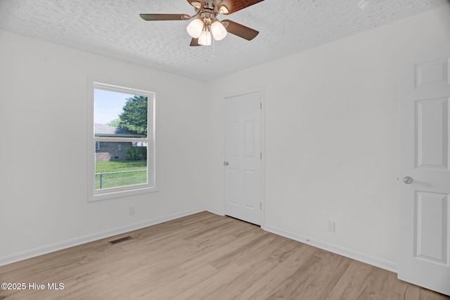 811 Crawford St, Goldsboro, NC 27530 - empty room featuring a textured ceiling, a ceiling fan, light wood-style flooring, and visible vents