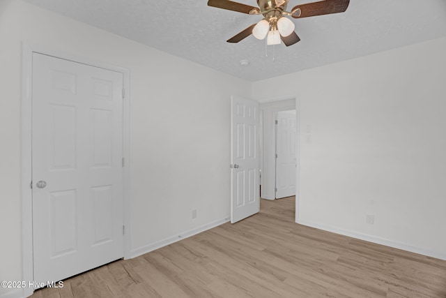 811 Crawford St, Goldsboro, NC 27530 - unfurnished bedroom featuring a ceiling fan, baseboards, and light wood-type flooring