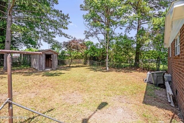 811 Crawford St, Goldsboro, NC 27530 - view of yard featuring an outdoor structure, a fenced backyard, and a shed