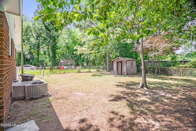 811 Crawford St, Goldsboro, NC 27530 - view of yard featuring a storage shed, an outdoor structure, central AC unit, and a fenced backyard