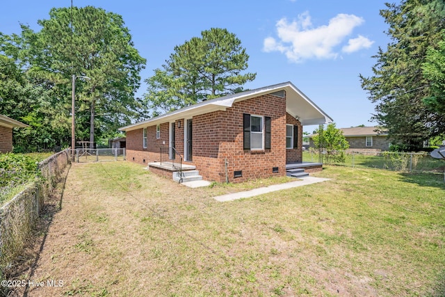 811 Crawford St, Goldsboro, NC 27530 - view of property exterior featuring a yard, crawl space, brick siding, and a fenced backyard