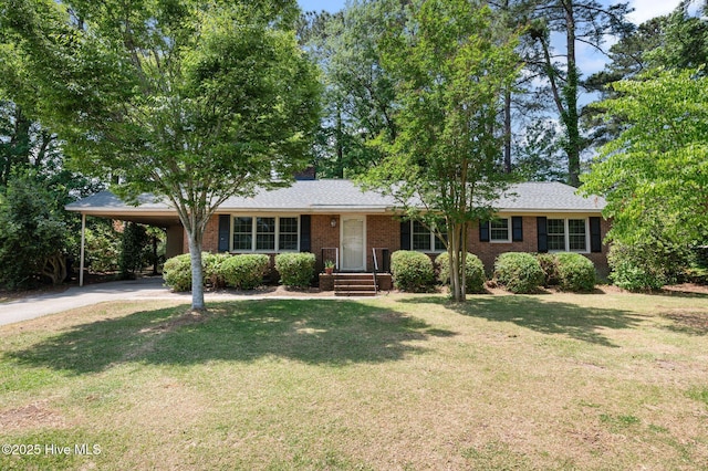 ranch-style home featuring brick siding, driveway, a front lawn, and a carport