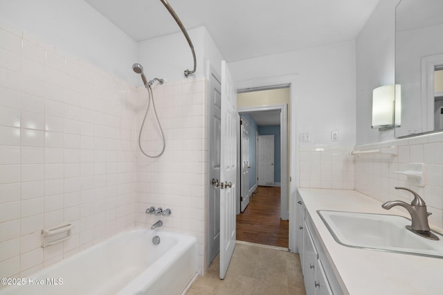 bathroom featuring vanity, tile patterned flooring, and bathtub / shower combination