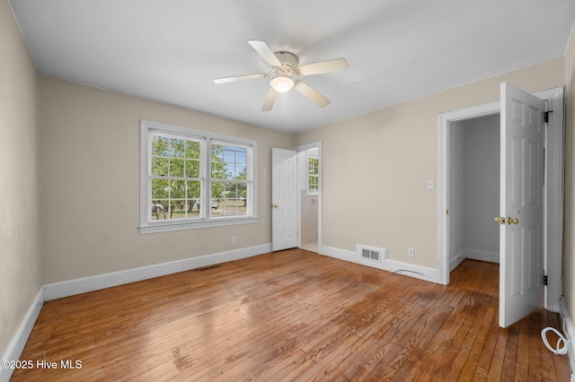 unfurnished bedroom with visible vents, baseboards, and light wood-type flooring