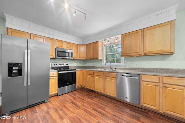kitchen featuring track lighting, light brown cabinetry, a sink, dark wood finished floors, and appliances with stainless steel finishes