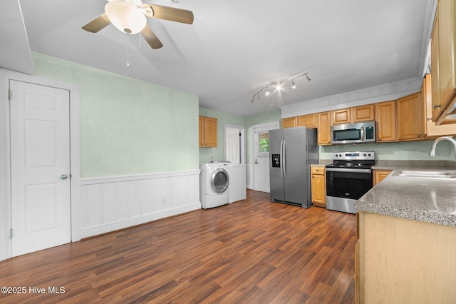 kitchen featuring dark wood-style flooring, ceiling fan, appliances with stainless steel finishes, wainscoting, and a sink