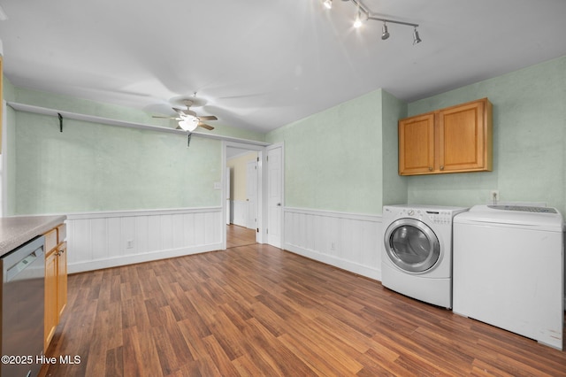 laundry room featuring laundry area, a ceiling fan, wood finished floors, and washer and clothes dryer