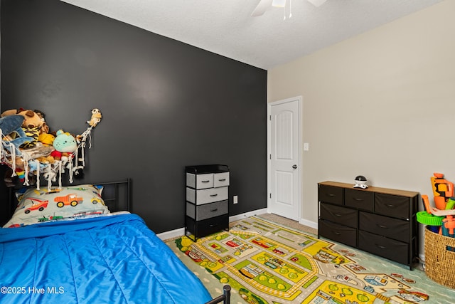 bedroom with baseboards, a ceiling fan, and light colored carpet