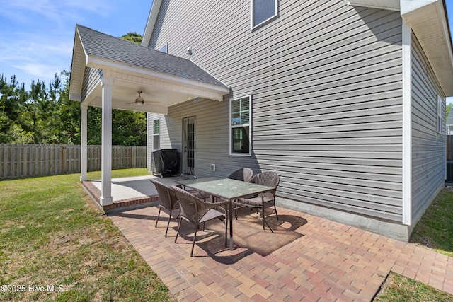 view of patio / terrace featuring area for grilling, fence, a ceiling fan, and outdoor dining space