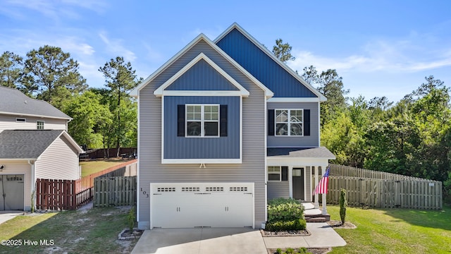 view of front of home featuring board and batten siding, driveway, fence, a front lawn, and an attached garage