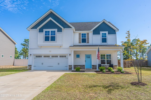 craftsman-style home featuring fence, an attached garage, a front lawn, board and batten siding, and covered porch