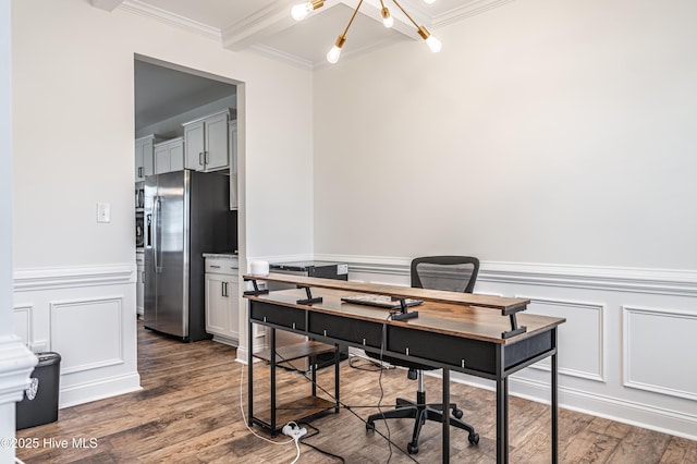 office area with ornamental molding, beamed ceiling, a decorative wall, and wood finished floors
