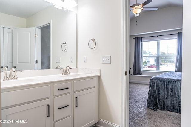 full bath featuring double vanity, a sink, ceiling fan, and vaulted ceiling
