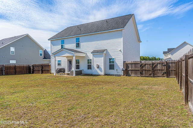 rear view of property with a fenced backyard, a patio area, a yard, and a shingled roof