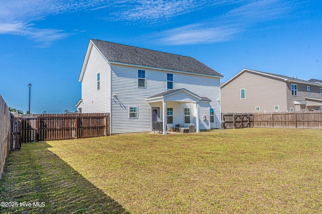 back of house featuring a patio, a fenced backyard, and a lawn