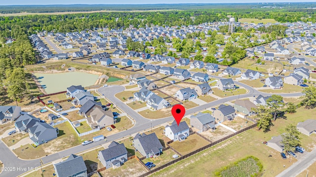 bird's eye view featuring a water view and a residential view