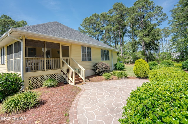 1071 Ridge Walk Way NW, Calabash, NC 28467 - view of front of home with a sunroom, a patio area, and roof with shingles
