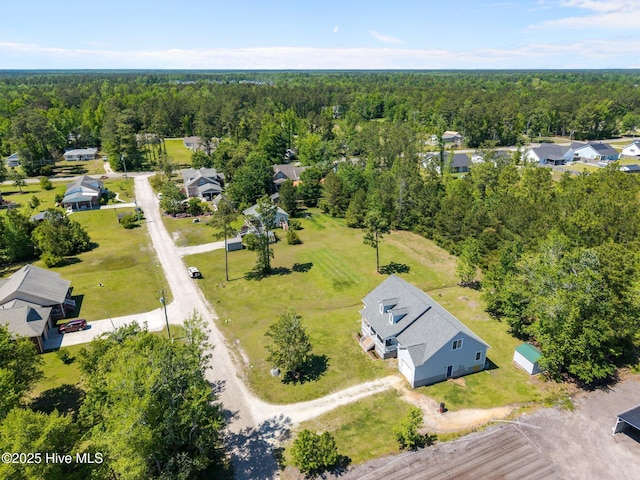 drone / aerial view featuring a wooded view