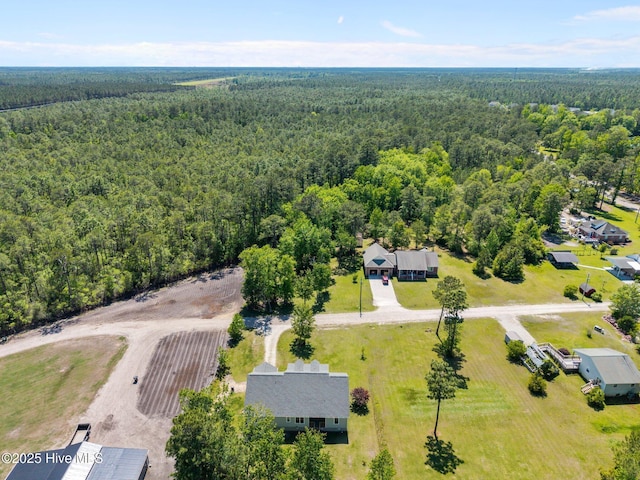 birds eye view of property with a forest view