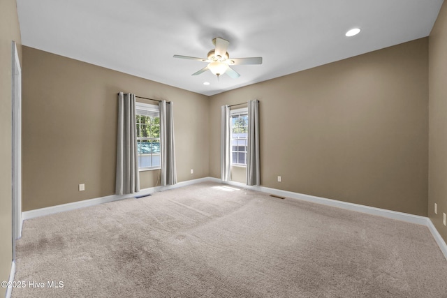 unfurnished room featuring baseboards, a ceiling fan, and carpet