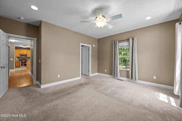 unfurnished bedroom featuring baseboards, recessed lighting, a ceiling fan, and light carpet