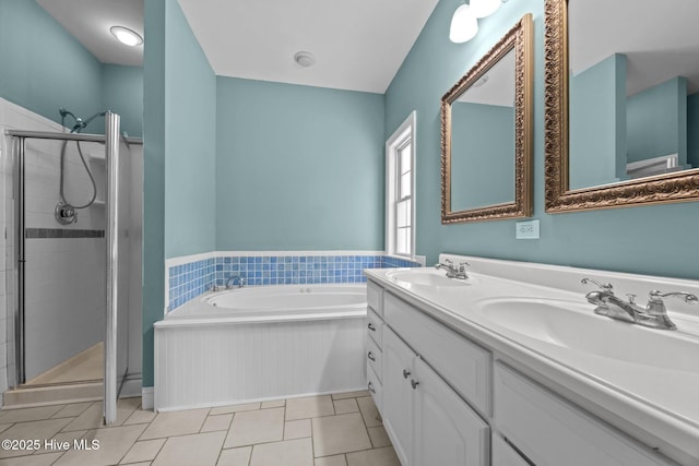 full bathroom featuring a sink, double vanity, a shower stall, and a garden tub