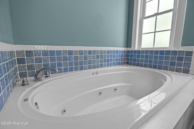 full bathroom with a whirlpool tub