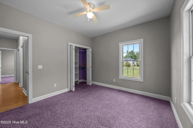 unfurnished bedroom with carpet flooring, a ceiling fan, baseboards, and a closet