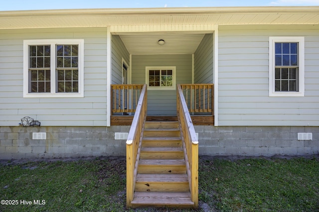 property entrance featuring a porch and crawl space