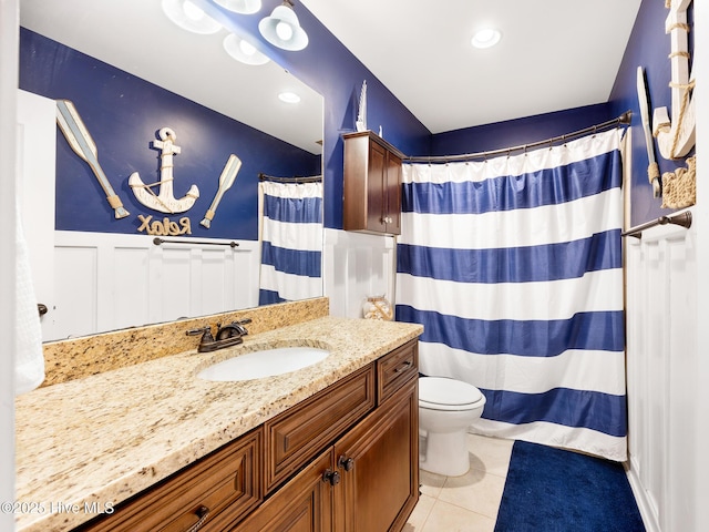 114 Schever Rd, West End, NC 27376 - full bath featuring wainscoting, tile patterned flooring, vanity, toilet, and a shower with shower curtain